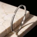 Elegant silver-toned titanium steel bangle with pavé-set sparkling star pattern stones - Silver with Rhinestones