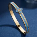 Gold stainless steel bangle with blue enamel and sparkling four-leaf clover charm. - Light Blue Four Leaf Clover (40甲-B-2)