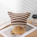 Hand-knitted brown and beige striped cat ear beanie displayed on a wooden stand. - One Size / Beige Coffee
