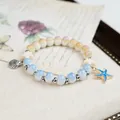 Handmade Jingdezhen ceramic beaded bracelet with blue starfish and seashell charms. - Foggy Island Star Style (1821-01) / Blue Beige