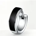 Close-up of a silver-toned stainless steel hoop earring featuring a black enamel inlay design - Antique Silver