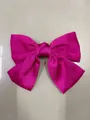 Macro view showcasing the vibrant fuchsia satin fabric and fold details of the bow - Rose Red Duckbill Clip