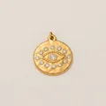 Gold plated stainless steel evil eye pendant with clear crystal inlay on textured background - Little Evil Eye Pendant