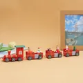 Detalle de tren de madera navideño con figuras festivas para la decoración de mesa - Ruedas Móviles 5817