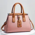 Vista ravvicinata di una borsa da donna rosa a grana litchi con manici superiori marroni - 28x14x20cm / Rosa