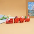 Detailed close-up of a red wooden Christmas train set on a warm and cozy desk setup - 1998 Red