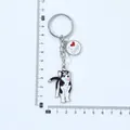 Detail shot of a cartoon husky keychain with a ruler showing it's about 10cm long. - Head-Tilting Husky