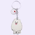 Detail view of a white Samoyed cartoon dog keychain made of zinc alloy with heart tag. - White Pomeranian