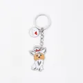 Close-up detail of a cute cartoon dog keychain with an I Love Dogs round metal charm - New Maltese