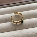 Close-up of retro gold star ring with green malachite stone inlay - Pentagram Hollow Oval Green Gemstone Style (JZ0365) / Adjustable Open Ring (2cm) / Green