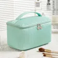Mint green pleated waterproof PU cosmetic bag with handle and double zipper close-up - Cylinder Style Light Blue