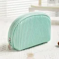 Elegant mint green pleated PU leather makeup bag with minimalist travel storage design. - Half Round Light Blue