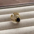 Close-up detail of a vintage gold open ring featuring a polished oval black gemstone. - Woven Texture Oval Black Gemstone Style (JZ0371) / Adjustable Open Ring (2cm) / Black
