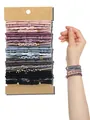 Close-up detail of bohemian style elastic hair ties and braided bracelets worn on wrist - Concentric Buckle Korean Style