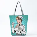 Close-up of a pop art style nurse illustration on a mint green polka dot tote bag - Mint Green Pop Art Nurse Style (hl1236)