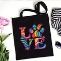Black canvas tote bag featuring a colorful paw print LOVE graphic for daily shopping - LOVE Art Paw Style (No. 6) / 35x40cm