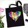 Stylish black canvas tote bag featuring a vibrant rainbow paw print heart graphic design - Paint Drip Rainbow Paw Heart Style (No. 14) / 35x40cm
