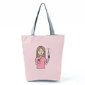 Pink tote bag with cute cartoon nurse print holding a syringe, grey handles. - Pink Cartoon Nurse Illustration Style (hl1553)