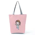 Detailed view of pink tote bag with cute nurse cartoon print and gray handles - Light Pink Chibi Nurse Illustration Style (hl1555)