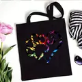 Black canvas tote bag featuring a vibrant paw print heart design for daily use. - Gradient Painted Paw Style (No. 10) / 35x40cm