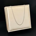 Silver stainless steel box chain necklace displayed on a champagne satin jewelry board. - Box Chain / 40+5cm / Silver