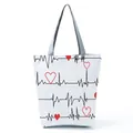 Eco-friendly white tote bag featuring red hearts and heartbeat lines on a grid background. - White ECG Red Heart Style (hl2324)