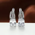Elegant silver hoop earrings featuring large oval clear stones and brilliant accents. - White Gold With White Zirconia