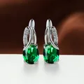 Elegant oval green gemstone earrings with silver-toned setting and sparkling CZ accents - Platinum Plated Green Zirconia