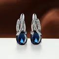 Elegant silver-tone earrings with large oval dark blue stones and crystal accents - Platinum Plated Royal Blue