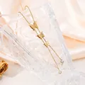 Detailed view of gold butterfly necklace with crystal pendants on glass vase - Three Butterfly Double Zirconia Style (20260130 Style 22)