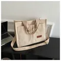Beige corduroy tote bag with multiple pockets and adjustable shoulder strap. - Khaki