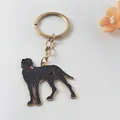 Detailed close-up view of a black dog enamel keychain with a gold-tone metal ring for keys - Black Dog Style
