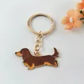 Close-up detail of a brown dachshund dog enamel keychain with a golden metal ring and chain - Dachshund Style 1