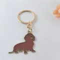 Detailed view of a golden metal dachshund dog keychain with brown enamel finish - Dachshund Style 2