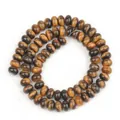 Detailed macro view of 5x8mm natural tiger eye stone abacus spacer beads for DIY jewelry. - 5*8 Approx 70 Beads per Strand / Tiger Eye Style (15)