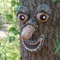 Detailed view of a funny resin tree face sculpture mounted on bark for garden decor. - Male Organ Style