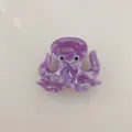 Macro detail of a cute purple marble acetate octopus animal hair claw clip for women - Octopus