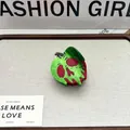 Halloween acetate hair claw clip featuring a green and red poison apple skull design. - Poison Apple