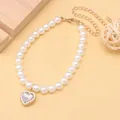 Elegant white pearl pet collar featuring a sparkling rhinestone heart pendant detail - White