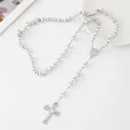 Close-up detail of a white beaded stainless steel rosary necklace with cross pendant - White Pearl / 6mm / Gold