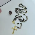 Detailed view of stainless steel rosary necklace with black gold beads and cross - Black Beads / 8mm / Gold