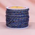 Spule mit blau-grauem viersträngigem Baumwollfaden mit glänzenden Golddraht-Akzenten - Grau-Navyblau