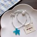 Detailed view of summer island beaded necklace featuring blue starfish and shell charms. - No.1 Dark Blue Starfish