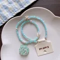 Close-up of summer beaded necklace featuring a shell pendant and a starfish charm. - No.5 Blue Glitter Shell