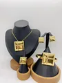 Detail of a 4-piece gold stainless steel jewelry set with square embossed design - 3D Square Cross Rope Gold (LX010022 Gold)