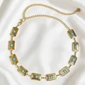 Catena da vita boho vintage in metallo dorato con pietre turchesi e quadrati geometrici. - Oro Antico