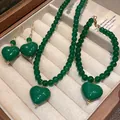 Detailed view of green agate-style jewelry set with heart pendants in a gift box. - Bracelet Earrings Necklace - Green