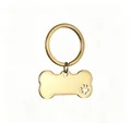Gold bone-shaped pet ID tag made of stainless steel with a hollow paw print detail - Gold (With Loop)