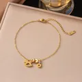 Elegant gold titanium steel anklet featuring a rocking horse charm and K18 logo tag - Wealthy Horse (B90) / Gold