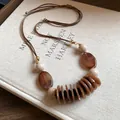 Bohemian style brown resin bead necklace with vintage aesthetic on adjustable cord - Necklace-Coffee